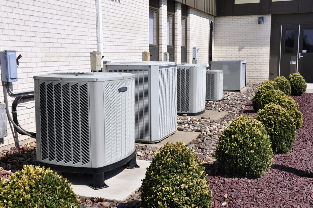 A row of commercial HVAC condenser units installed outside a building by RP Services llc, heating & air conditioning in Louisville, KY.