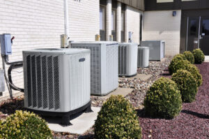 A row of commercial HVAC condenser units installed outside a building by RP Services llc, heating & air conditioning in Louisville, KY.