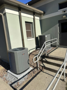 Two commercial HVAC condenser units installed outside a building entrance by R&R Climate Systems in Newark, NJ