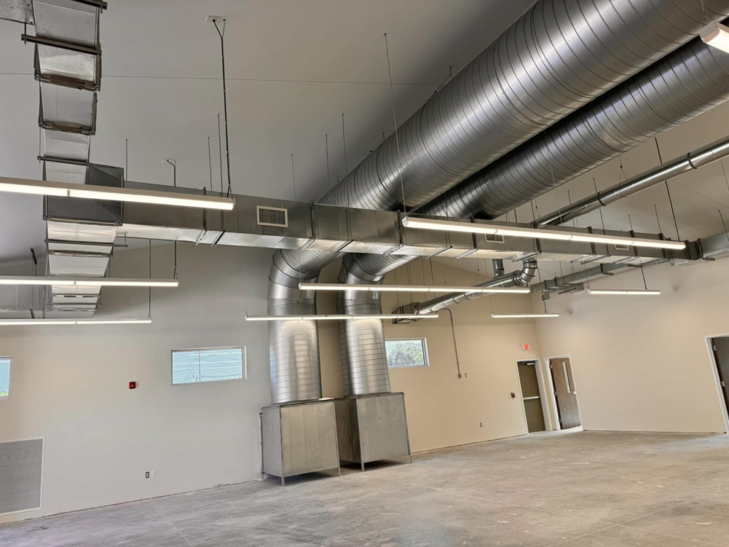 Commercial HVAC duct installation with large round and rectangular ducts by Buck'n Bull HVAC Solutions in Wilmington, NC