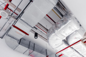 Extensive commercial HVAC ductwork and piping installed on a ceiling by Climate Control in San Antonio, TX
