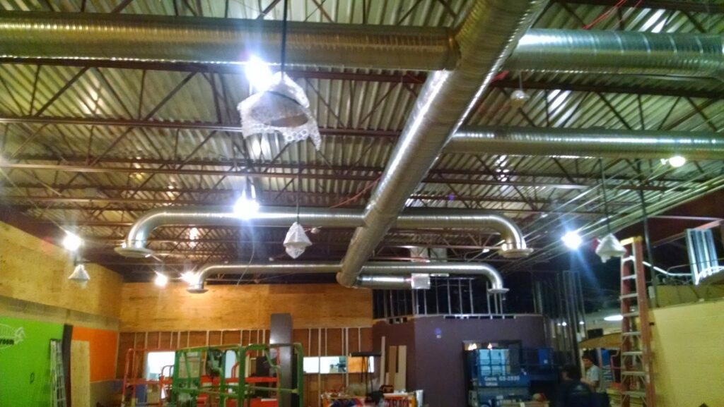 Commercial HVAC ductwork installation in a building by Collins Cooling and Heating in Cleveland, OH.