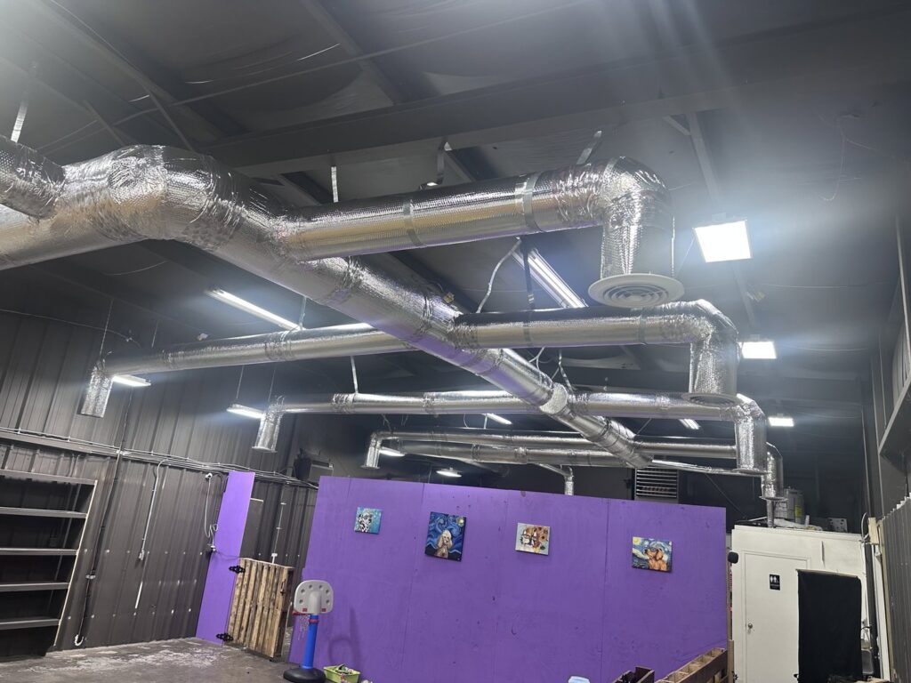 Large insulated HVAC ductwork installed in a commercial building by Comfort Temp HVAC LLC in Fort Smith, AR