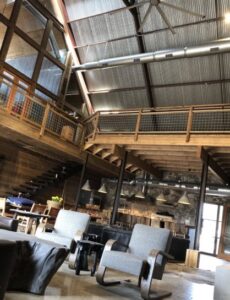 Exposed commercial HVAC ductwork and ceiling fans in a modern building, installed by Eagle Heating & A/C in San Antonio, TX.