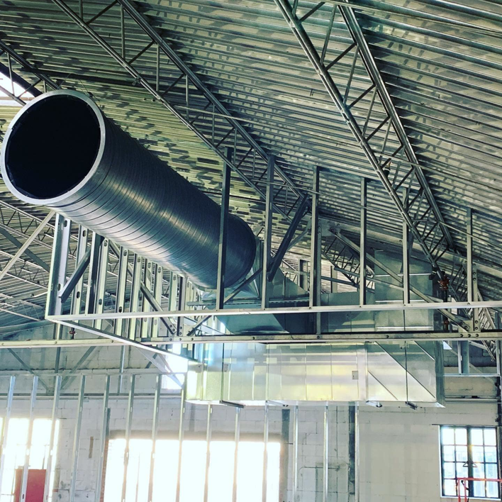 Large commercial HVAC ductwork installed in a building under construction by Elemental Air in Sanford, FL.