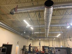 Large commercial HVAC ductwork installation in a ceiling by Elite Heating and Cooling in Livonia, MI.
