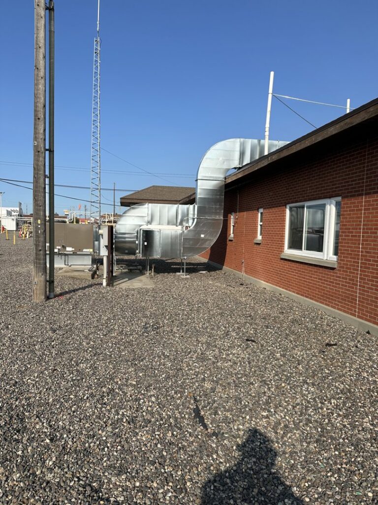 Large commercial HVAC ductwork and units installed on the exterior of a building by Encode Corporation in Billings, MT.