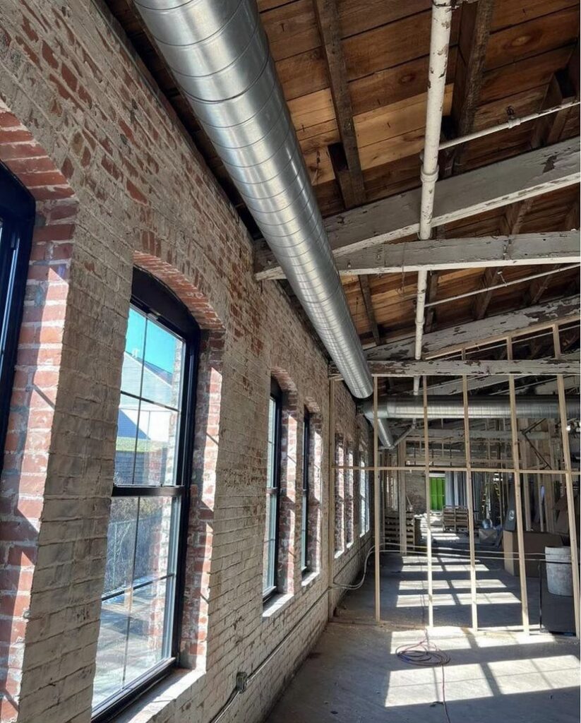 Interior view of a commercial space under construction with new HVAC ductwork installed along the ceiling by SANKS Mechanical in Philadelphia, PA.