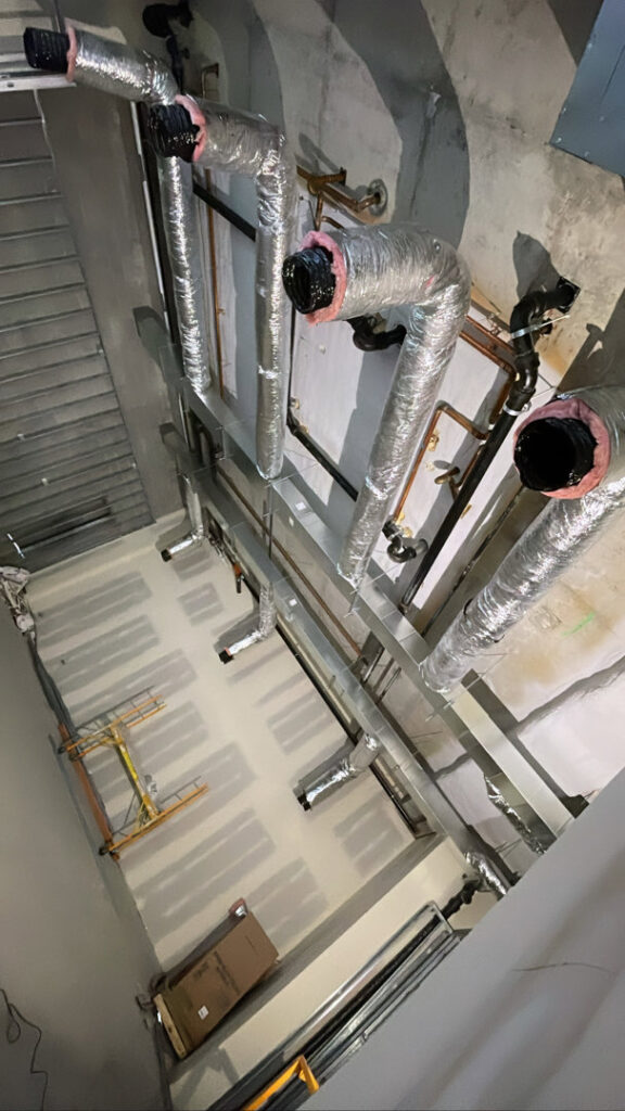 Complex commercial HVAC ductwork and piping installed in a ceiling by JL Heating & AC LLC in Chicago, IL