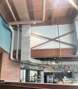 Exposed commercial HVAC ductwork and piping installed in a cafe by Major HVAC R Inc in Huntingdon Valley, PA