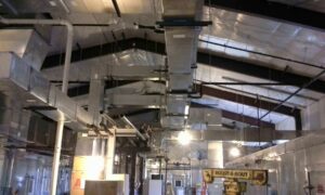 Extensive commercial HVAC ductwork and piping installed in a large building by Montefusco HVAC in Peoria, IL