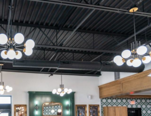 Exposed black commercial HVAC ductwork installed in a modern ceiling by On the Mark Heat & Air OKC in Oklahoma City, OK
