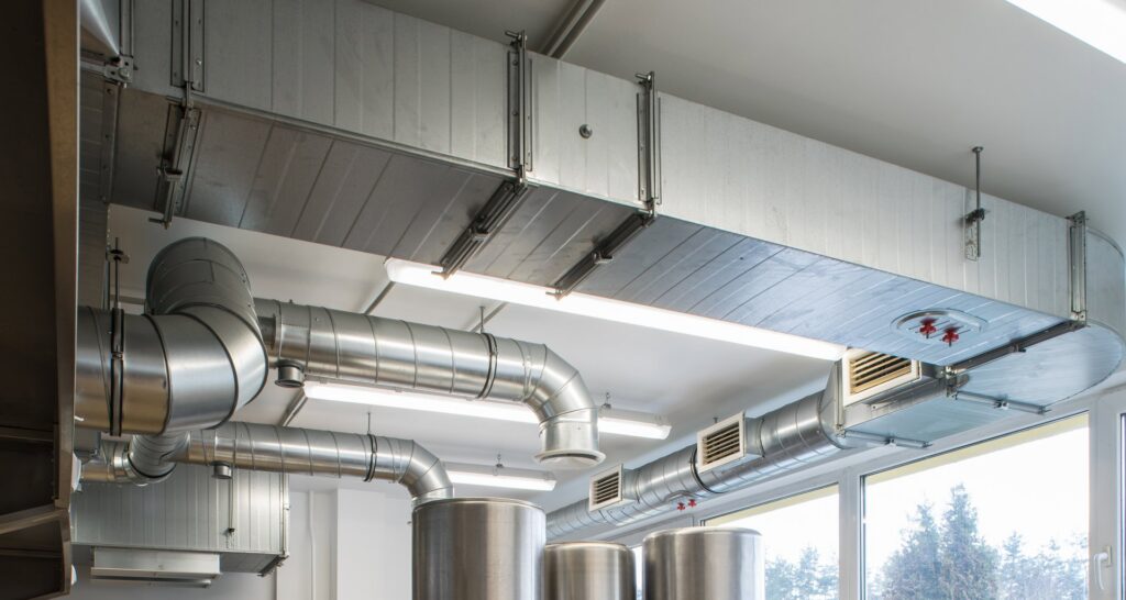 Large commercial HVAC ductwork and ventilation systems installed on a ceiling by Precision Vac in Thornton, CO.