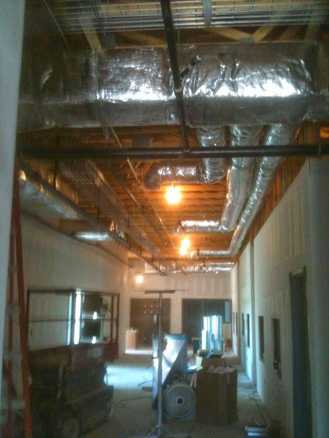 Exposed HVAC ductwork installed in a commercial building by R&B Cooling&Heating in Abbeville, LA.