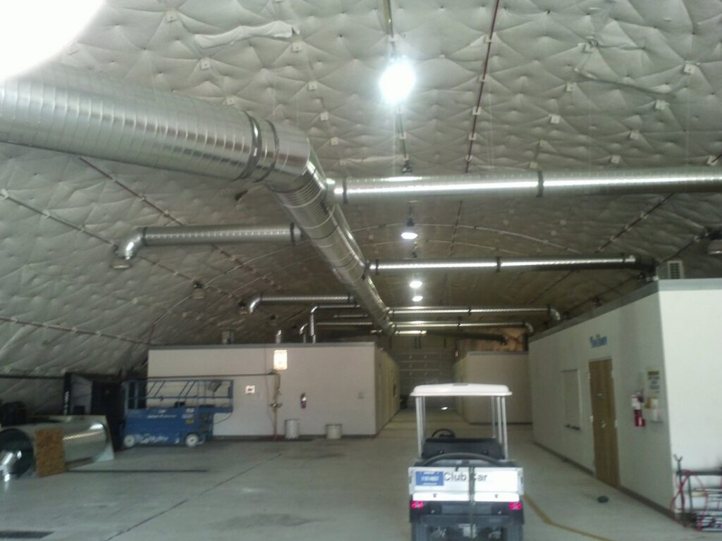 Large commercial HVAC ductwork installed in a warehouse by Raytech Refrigeration, Heating & Cooling in Alamogordo, NM.