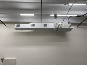 Commercial HVAC ductwork and vents installed high on a wall by T&D Air Conditioning in Fort Lauderdale, FL.