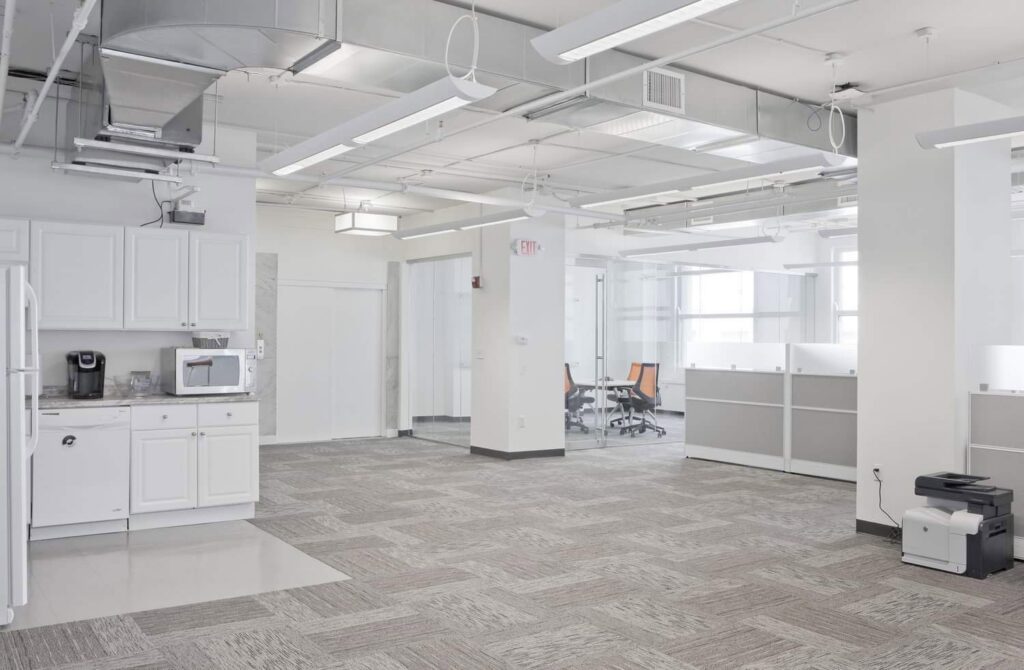 Commercial HVAC ductwork and vents visible in a modern office space by Atmos HVAC in Quincy, MA.