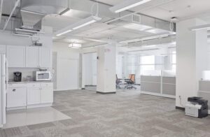 Commercial HVAC ductwork and vents visible in a modern office space by Atmos HVAC in Quincy, MA.