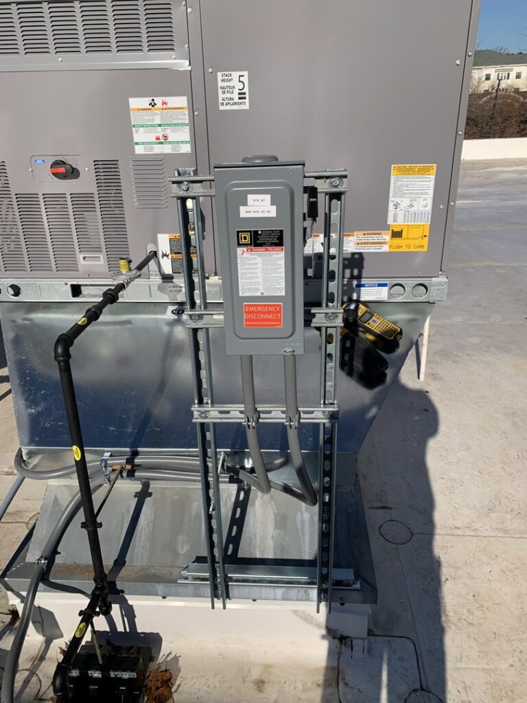 Commercial HVAC electrical disconnect switch installation on a rooftop by Oak Electric LLC in Waterford, MI.
