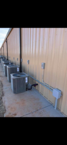 Commercial HVAC units with electrical conduit and wiring installed by Enid Electric in Enid, OK