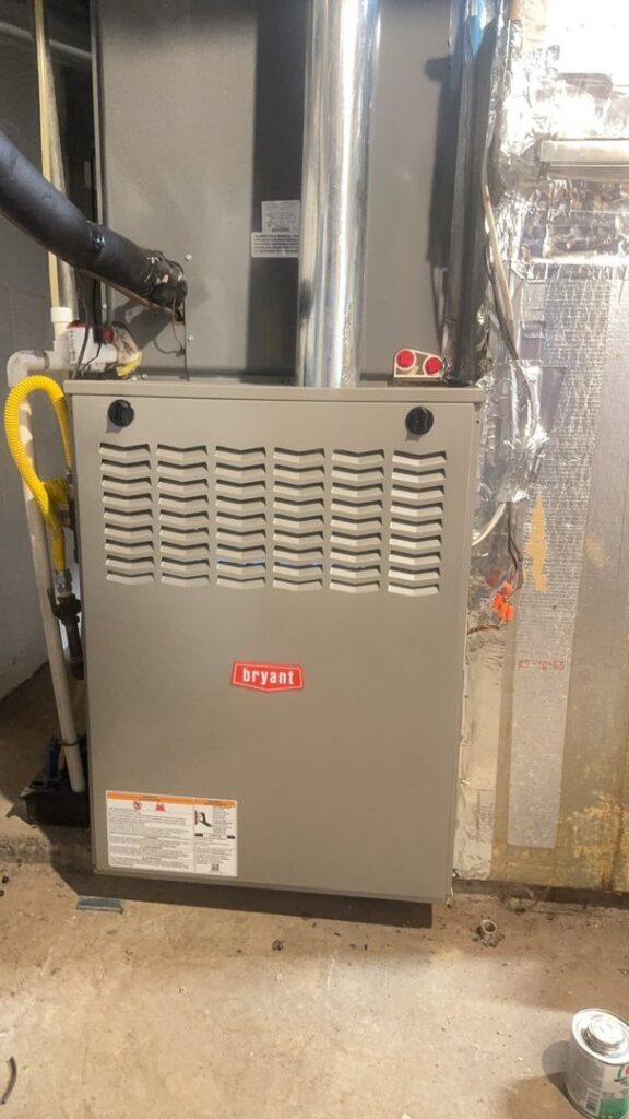 An outdoor commercial HVAC unit with vertical ductwork and a ladder, installed by Ware's Heating & Cooling in Georgetown, KY.