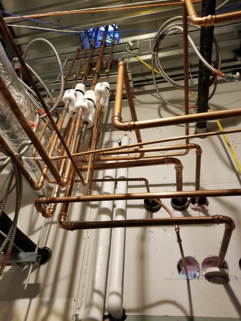 Complex copper and PVC piping for a commercial HVAC system installed by Comfort Systems of Virginia, Inc. in Chesapeake, VA.