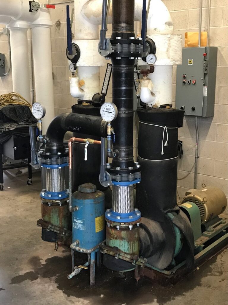 Large commercial HVAC pumps and intricate piping system installed by Evergreen Services in Warwick, RI.
