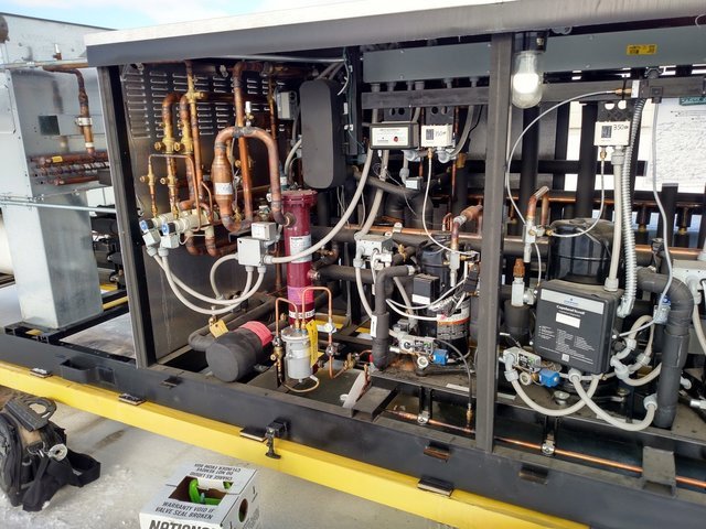Close-up view of the internal components of a commercial HVAC or refrigeration system serviced by Benck Mechanical Inc in Somerset, WI.