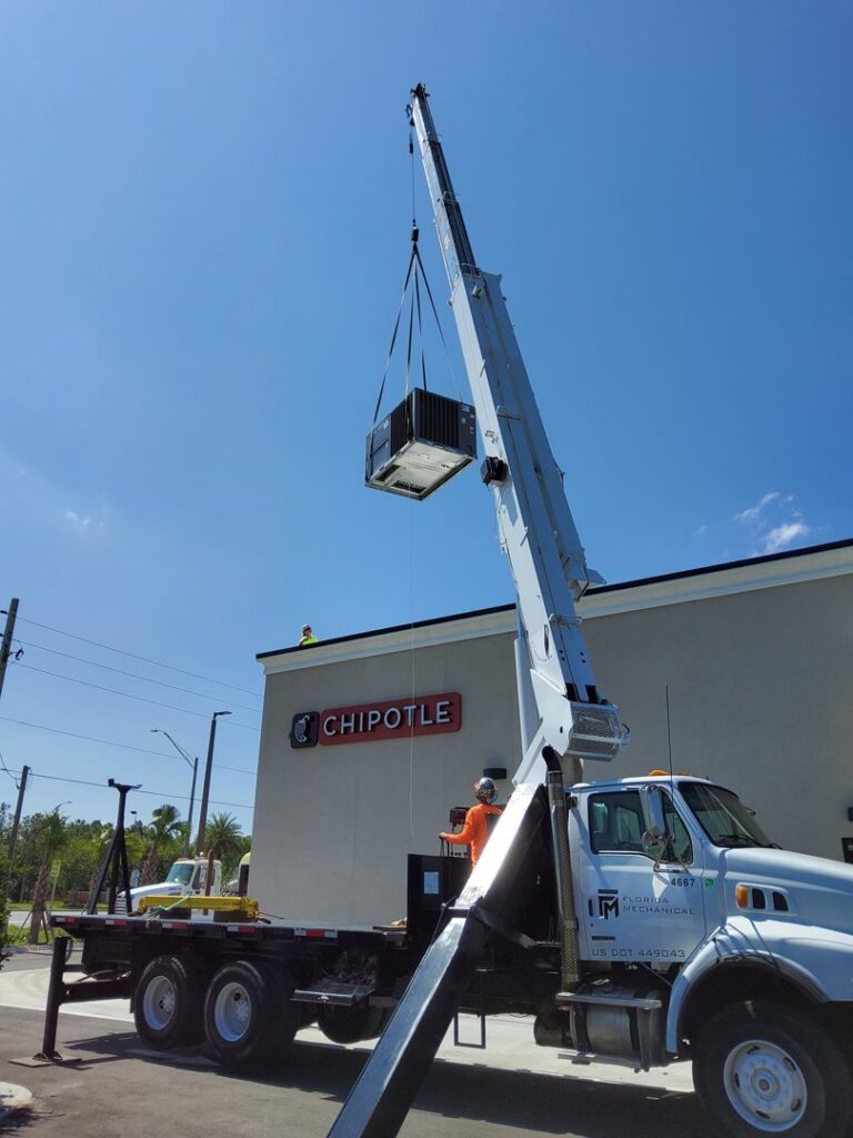 Commercial HVAC rooftop unit being installed by crane at a Chipotle by Huggins Mechanical in Jacksonville, FL
