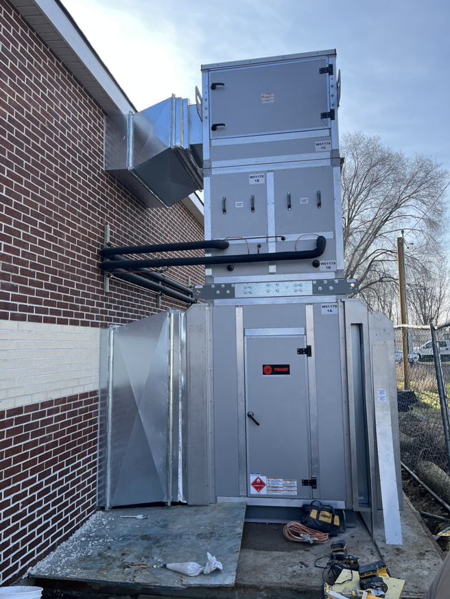 Large commercial HVAC system with ductwork installed on the exterior of a building by Atlas Heating and Air, LLC in Talent, OR