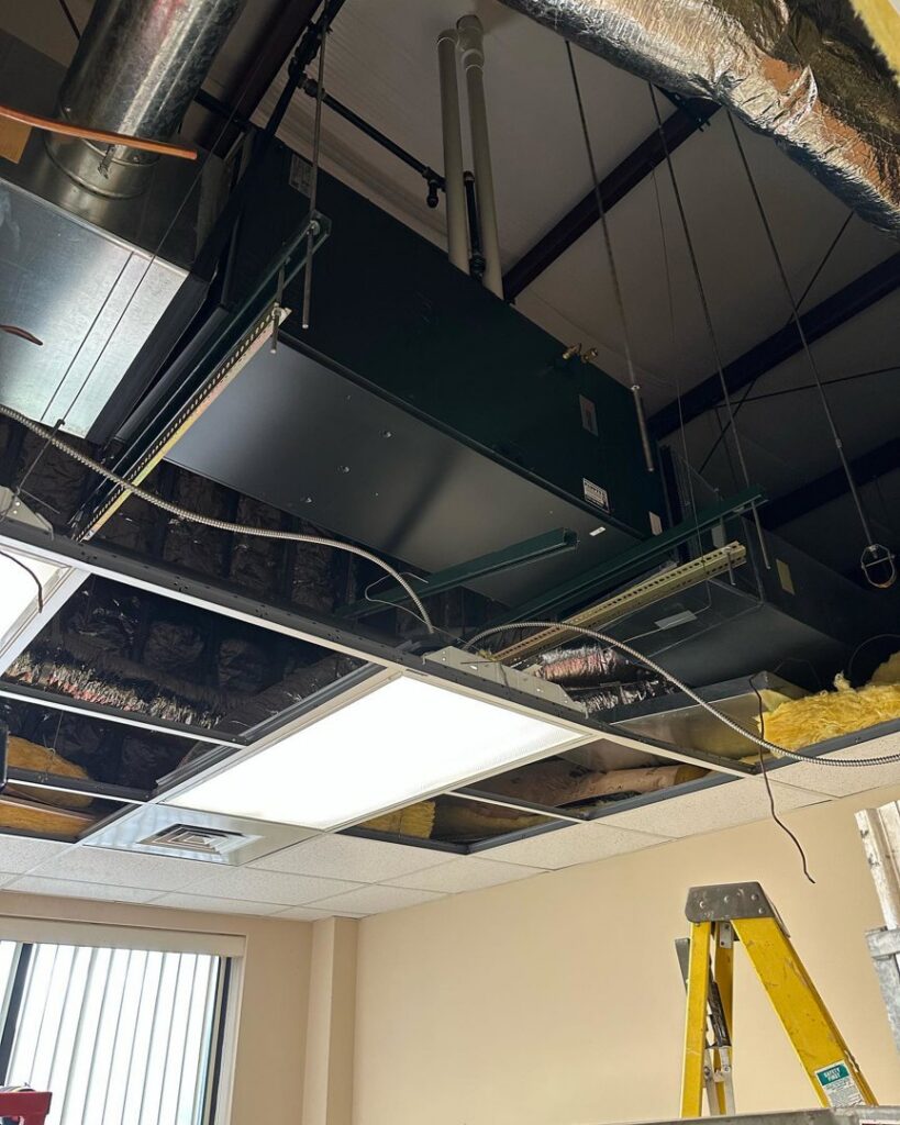 A large commercial HVAC unit installed in a ceiling by Pappy's Heating & Air INC for a business in Clayton, NC.