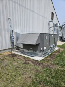A commercial HVAC unit installation next to a building by Advantage Mechanical, Inc. in Appleton, WI.