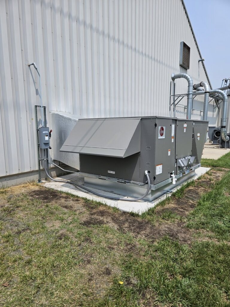 A commercial HVAC unit installation next to a building by Advantage Mechanical, Inc. in Appleton, WI.