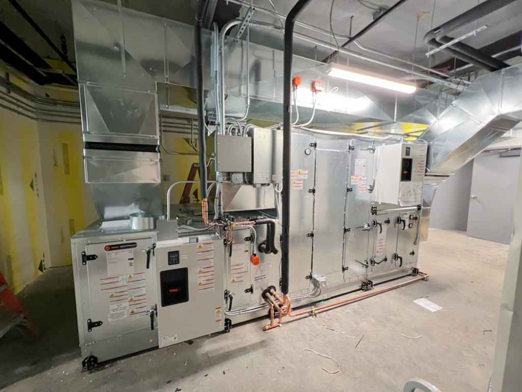 A newly installed commercial HVAC unit with ductwork and piping by Air Masters HVAC Services of New England, Inc. in Fall River, MA.