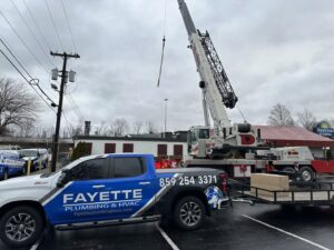 Commercial HVAC unit installation with a crane by Fayette Plumbing & HVAC in Lexington, KY.