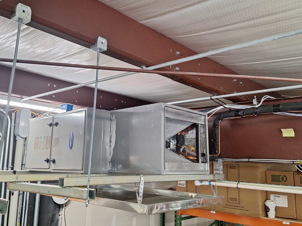 A commercial HVAC unit suspended from the ceiling in a building by Recovery HVAC in Smyrna, TN.