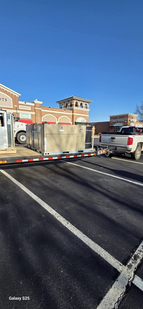 A commercial HVAC unit loaded on a flatbed trailer for Cordells Heating and Cooling in Greenville, SC.