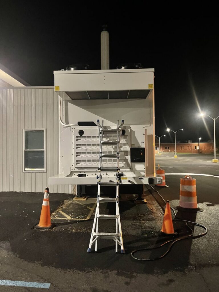 A large commercial HVAC unit on site with a ladder, ready for service by Best Plumbing Heating & Cooling Contractors in Albany, NY.