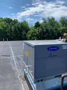 A newly installed Carrier WeatherMaker commercial HVAC unit on a rooftop by Air Quality, LLC in Cranston, RI