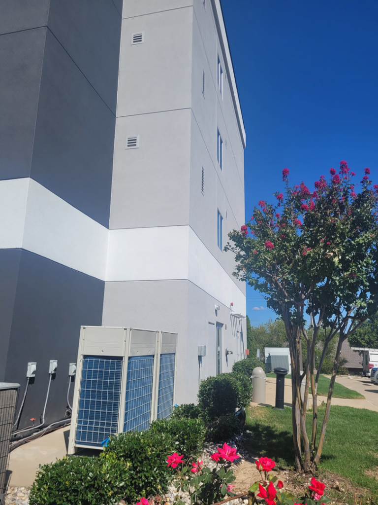 Outdoor commercial HVAC units installed along the exterior of a building by SleepRite Heating & Cooling in Conway, AR.