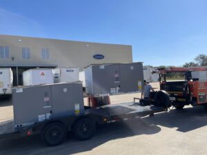 Large commercial HVAC units unloaded from a trailer with a forklift for installation by Benavidez Heating & Air Conditioning In, Arlington, TX.