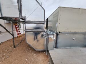 Commercial HVAC units and ductwork installed next to a building by Dynamic Heating, Cooling, Refrigeration & Roofing in El Paso, TX.