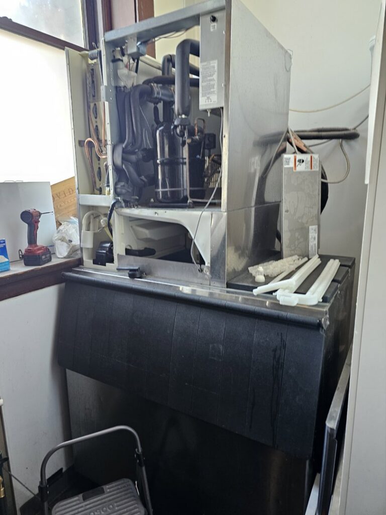 Internal components of a commercial ice machine during maintenance by Henry Refrigeration & Hvac Utah in Ogden, UT.