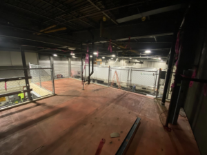 A commercial indoor chain-link enclosure installed on an upper level by Big Red Fencing LLC in Waverly, NE.