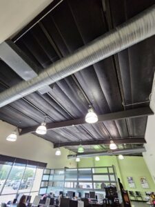 Modern commercial interior lighting and exposed ductwork installed by Apex Electric LLC in Brea, CA.