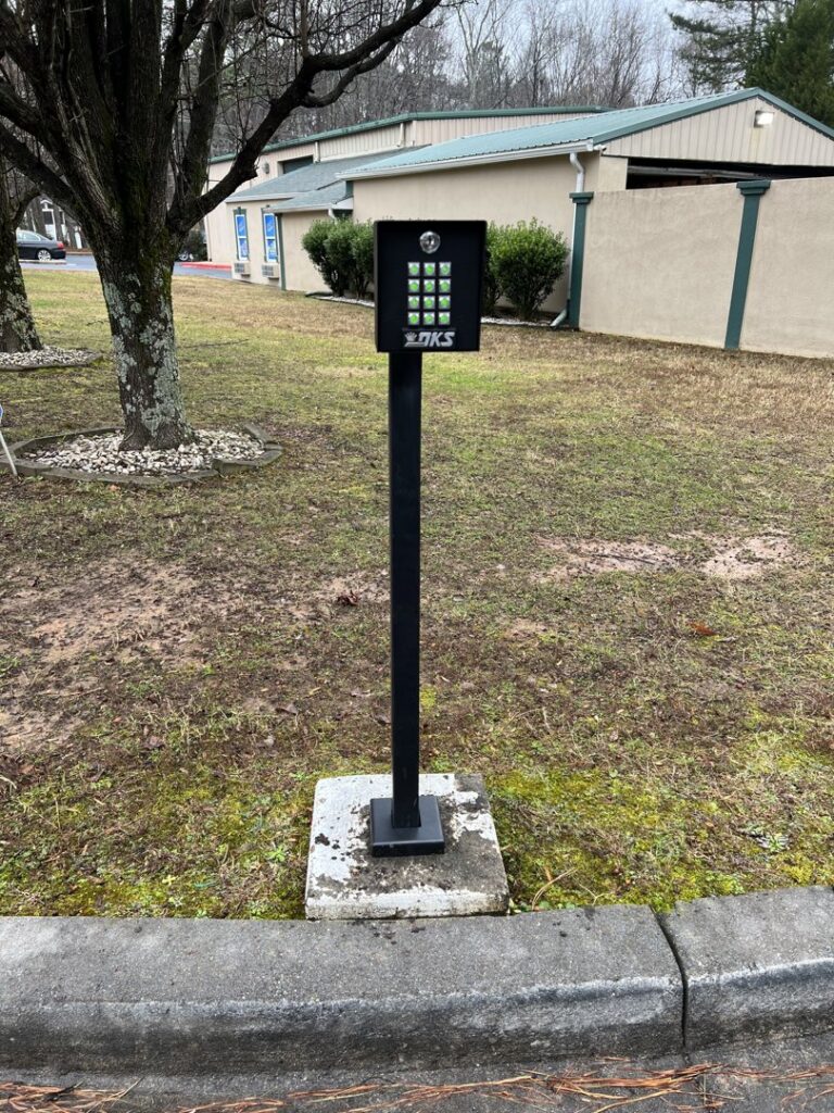 A commercial keypad entry system on a black post for gate access control by Gates Contractors in White, GA.