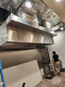 Installation of a large commercial kitchen exhaust hood and ductwork by OKIE Heating and Cooling in Tulsa, OK.