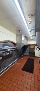 A commercial kitchen featuring a newly installed stainless steel exhaust system and ductwork by Butte Tin Shop, Inc. in Butte, MT.