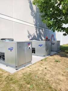 Three commercial Krack HVAC units installed outdoors by Complete Mechanical Solutions in Novi, MI