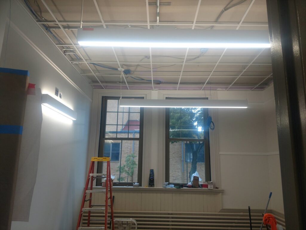 New commercial LED lighting fixtures installed on a ceiling grid by Icon West Corporation Electrical Contractors in Springfield, MA.